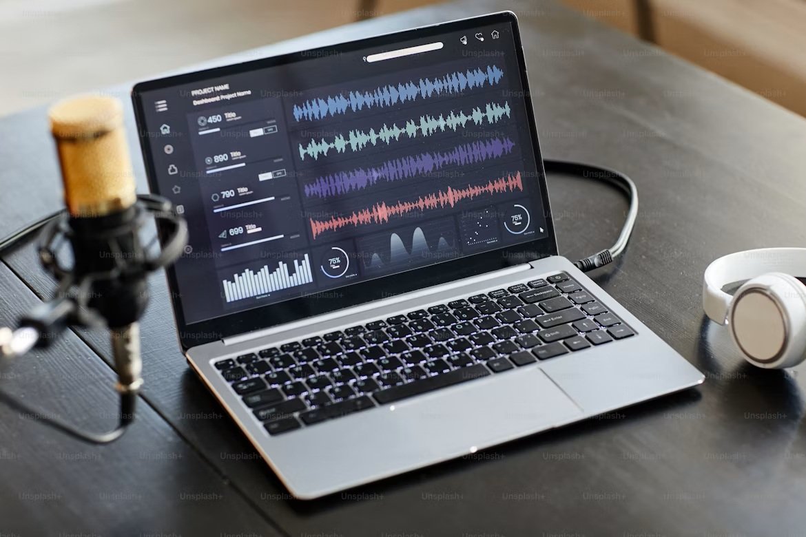 An independent rapper reviewing video editing and AI marketing analytics on a laptop in a recording studio.