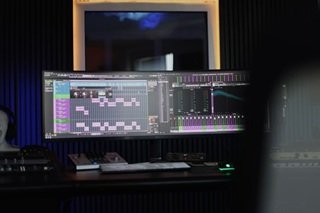 A digital audio workstation tracking interface showing multi-colored audio tracks, clip arrangements, and waveforms across a chronological timeline view.